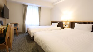 A hotel room with two beds, a desk, a chair, a TV, and a window with curtains. - KOKO HOTEL Sendai Station South (Sendai)