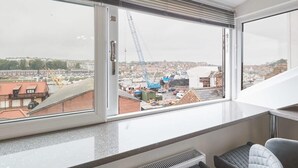 A modern room with a large window overlooking a construction site. - Host & Stay | Wadsworth Cottage (Whitby)