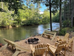 A riverside seating area with a fire pit and Adirondack chairs. - At the End of the Road. Toccoa River Front (Fannin County)