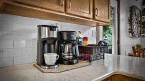 A kitchen with a coffee maker, a cup, and a basket on the counter. - At the End of the Road. Toccoa River Front (Fannin County)
