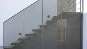 A staircase with a perforated metal design, leading to a higher level.