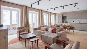 A spacious living area with a sofa set, a dining table, and a kitchen in the background. - Magnificent New Apartment  Beaubourg/Le Marais (Paris)