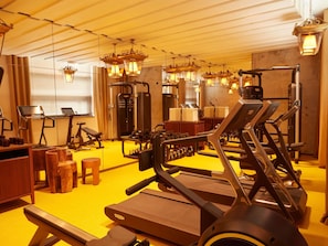 A gym with treadmills, weight machines, and exercise equipment.