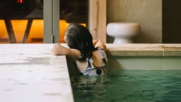 Guests can enjoy a serene pool experience with a setting and convenient bathroom access.