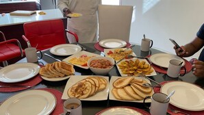 A breakfast buffet with various dishes, including pancakes, toast, and fruits, set on a table with red placemats and white plates. - Near Dunn's River Falls, w/Pool, Beach Access, A/C, WiFi, Playpen & baby bath (Ocho Rios)