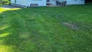 A single-story house with a front porch, a covered patio, and a well-maintained lawn. - Cozy ranch style home close to Virginia Spearhead and Hatfield McCoy Trailheads  (Pocahontas)