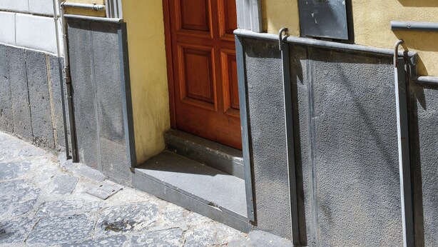 A building entrance with a wooden door, a mailbox, and a small window. - Angel's house in Sorrento coast (Meta)