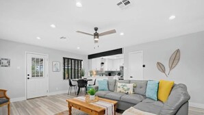 A modern living room with a grey sofa, wooden coffee table, and a patterned rug. - Casa Rockport - Waterfront + Pet Friendly
 (Rockport)