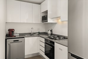 Enjoy cooking in this well-equipped kitchen with a gas stove, sink, and coffee maker.