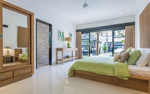 Relax in a serene space with a large bed, wooden headboard, and sliding door to a balcony with a view.