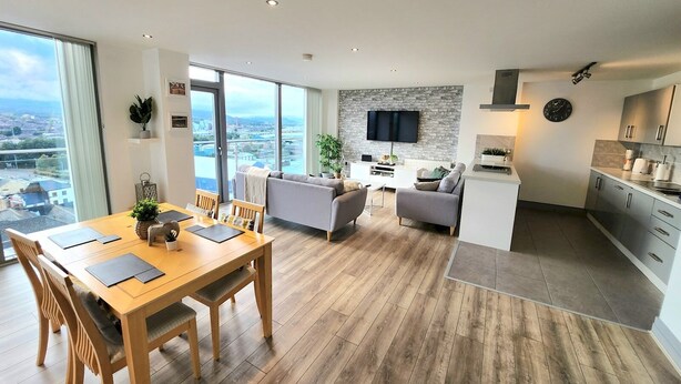 A modern apartment with a dining area, living room, and kitchen. - Stunning Penthouse with Balcony | Sunset Views - Pass the Keys (Belfast)