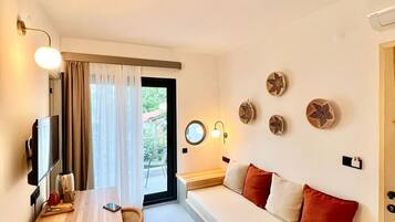 Deluxe Triple Room, 1 Bedroom | Living area | 50-inch LCD TV with satellite channels