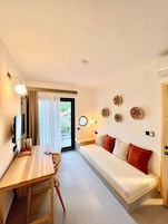 Deluxe Triple Room, 1 Bedroom | Living area | 50-inch LCD TV with satellite channels
