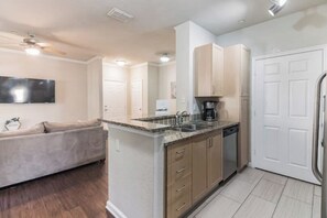 Enjoy cooking in this well-equipped kitchen with a central island, sink, and coffee maker.