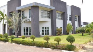 A modern building with a flat roof, large windows, and a symmetrical facade. - Moba Hotel & Convention Centre (Kitwe)
