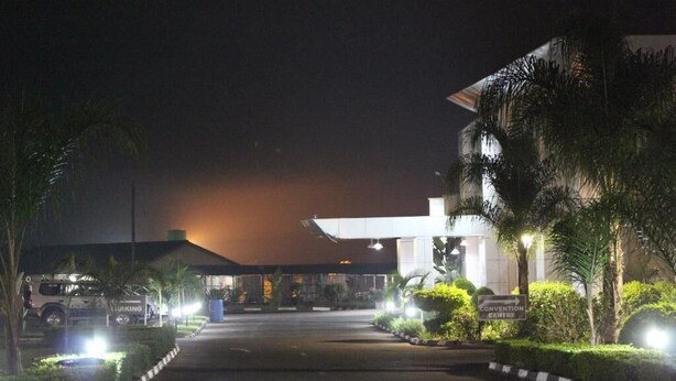 A hotel entrance at night with a convention center sign, a parking area, and well-lit pathways. - Moba Hotel & Convention Centre (Kitwe)