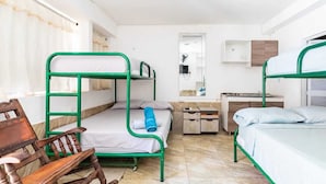 A dormitory room with bunk beds, a desk, a chair, and a mirror. - alborada hostel B&B  (Santa Marta)