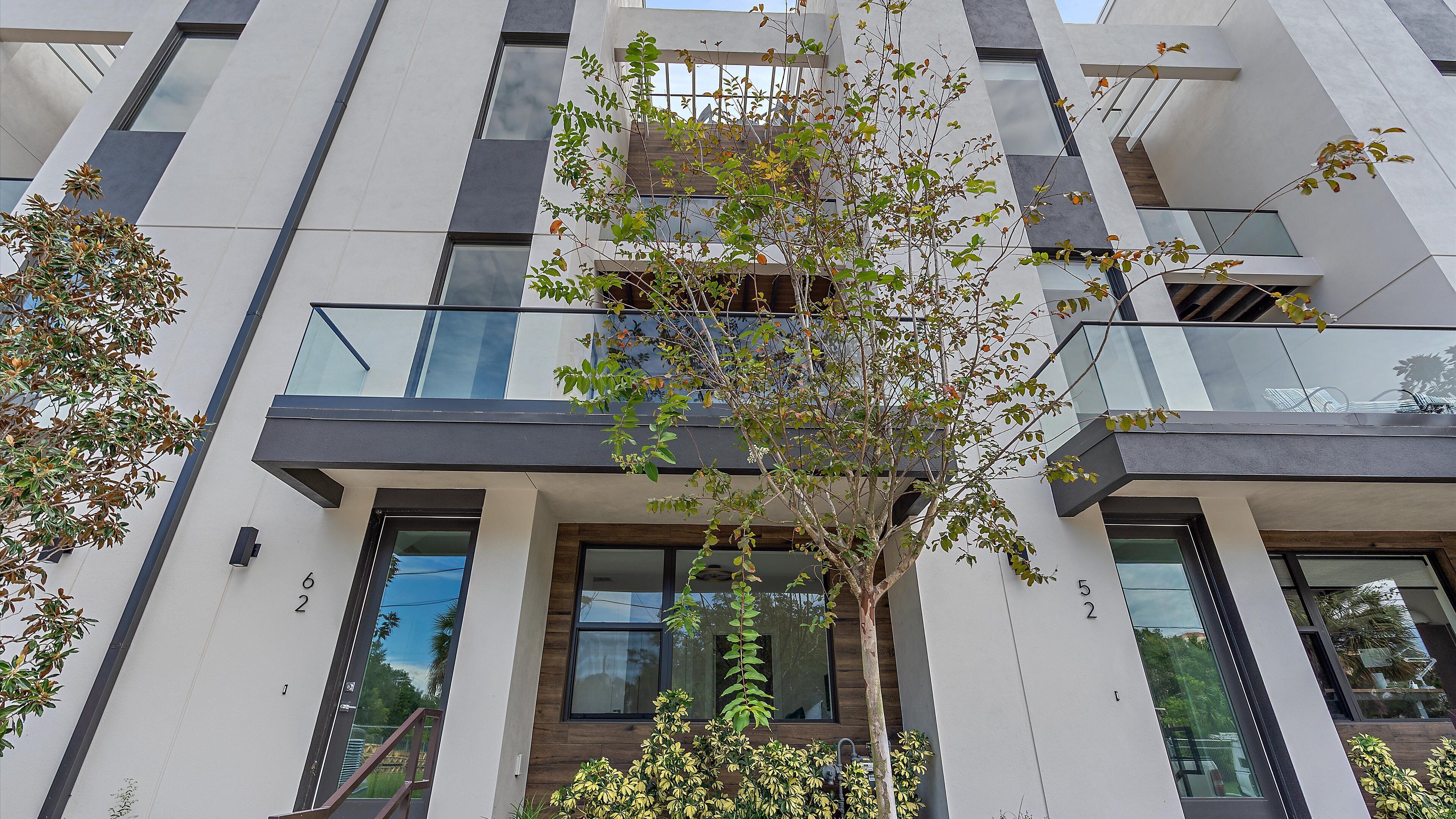 A modern building with multiple balconies and large windows.