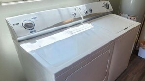 A front view of a white front-loading washer and dryer unit with a control panel on top. - Easy Living ~ Easy Playing, just a 5 minute walk from down town Cody. (Cody)