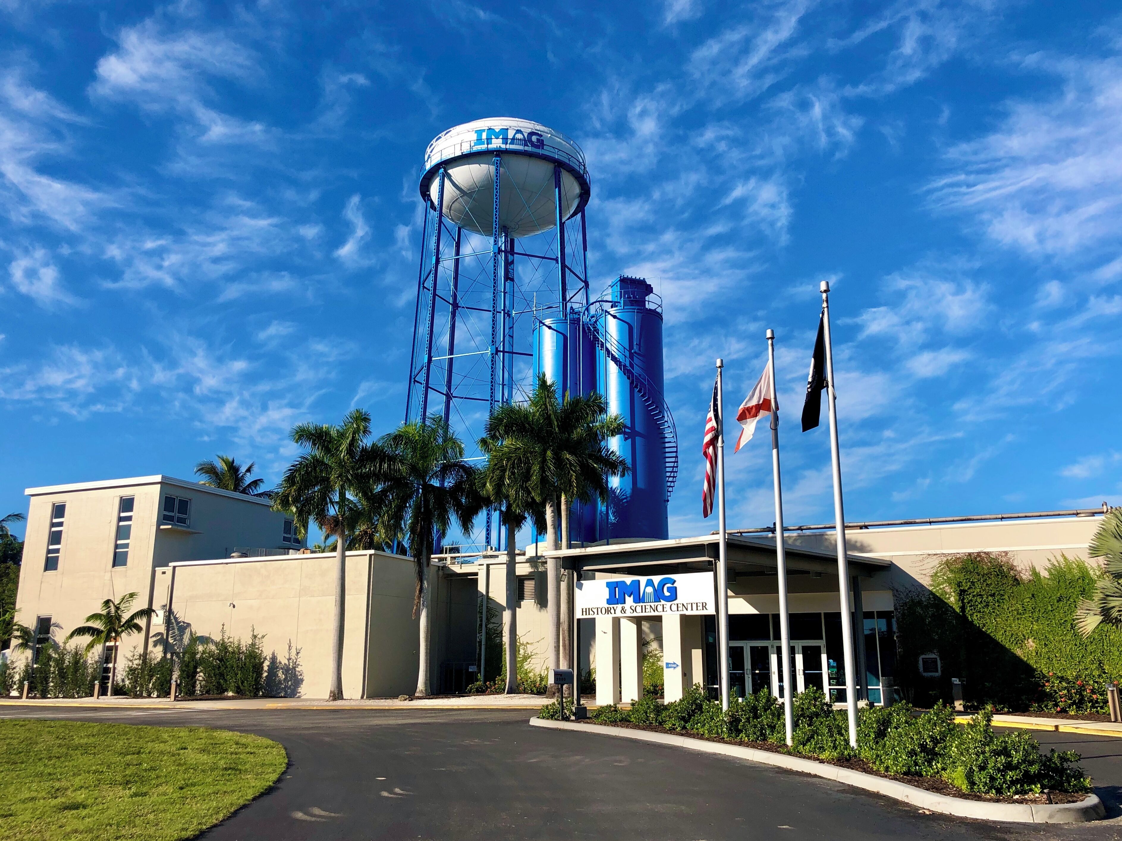 A building with a water tower labeled "IMAG" and a sign for the "History & Science Center".
