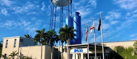 A building with a water tower labeled "IMAG" and a sign for the "History & Science Center".