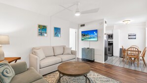 A modern living room with a sofa, coffee table, and artwork on the walls. - Venice Beach-Coco Palms 103. One block to Venice Beach.  (Venice)