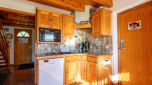 A compact kitchen with wooden cabinets, a built-in microwave, and a dishwasher. - wonderful Chalet 6 ppl, mountain view (Morillon)