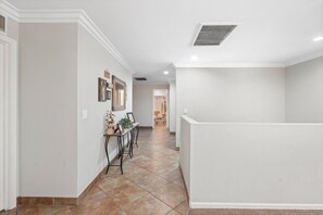 A hallway with a dining area, a mirror, and a door leading to another room. - Rainbow Lake Retreat: Lakeside Cabin for Big Families & Groups!
 (Pinetop-Lakeside)