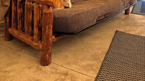 A rustic wooden sofa with a patterned blanket and pillows, set against a tented backdrop. - The Raven's Nest Teepee . Nestled in the Selkirk Mountain range, in Naples Idaho (Naples)