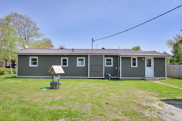 A single-story house with a grey exterior, a front porch, and a small playhouse in the yard. - BEAUTIFUL WATER FRONT AND BOATER LOVER (Orillia)