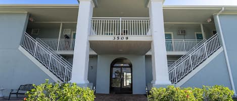 A two-story building with a balcony on the second floor, a number '3509' above the entrance, and a staircase on both sides.