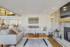 TV, fireplace - Lakefront house with private beach, firepit, dock, 4 kayaks, grill & hot tub (Gray)