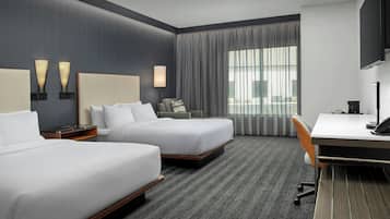 Premium bedding, desk, laptop workspace, blackout drapes