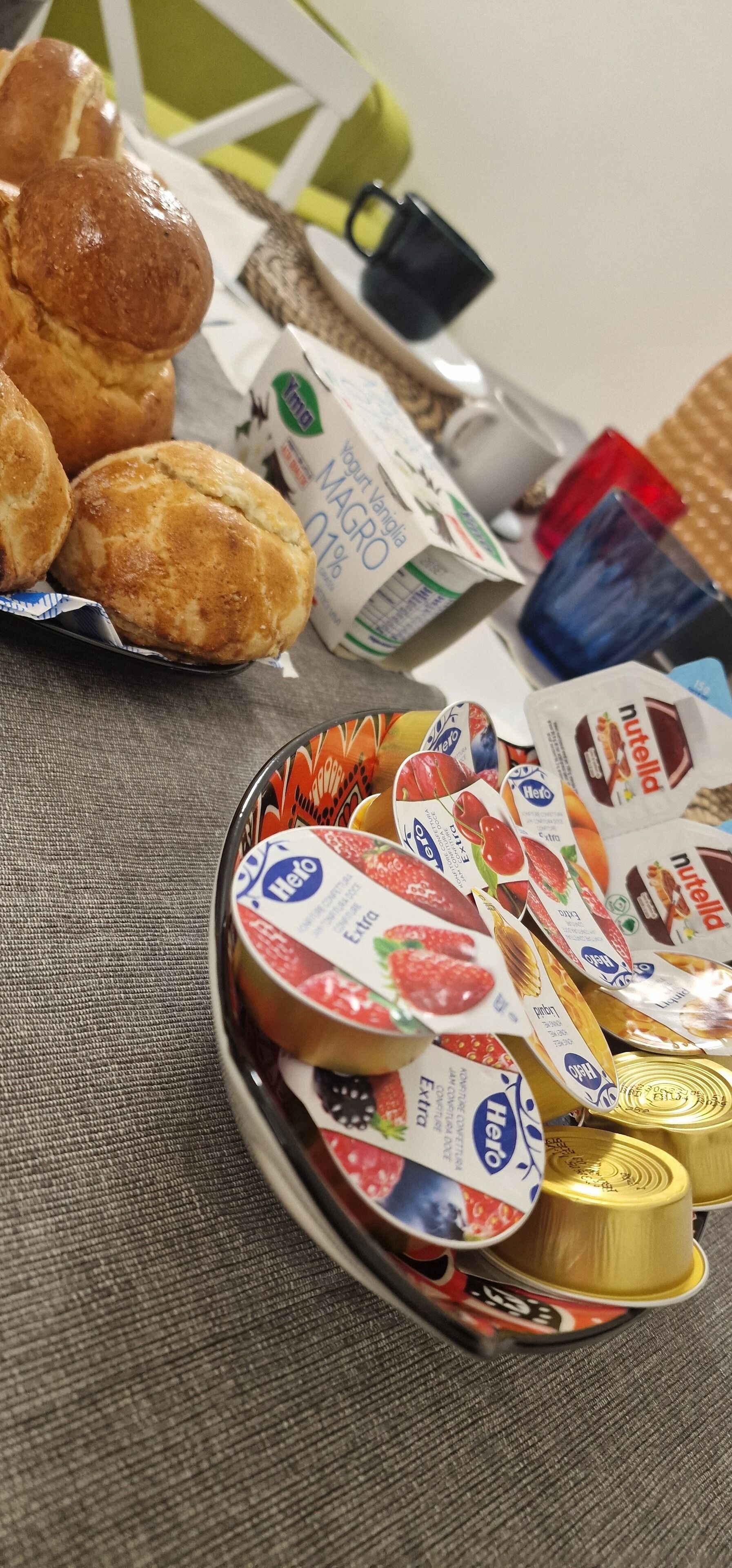 A breakfast table with pastries, yogurt, and Nutella.