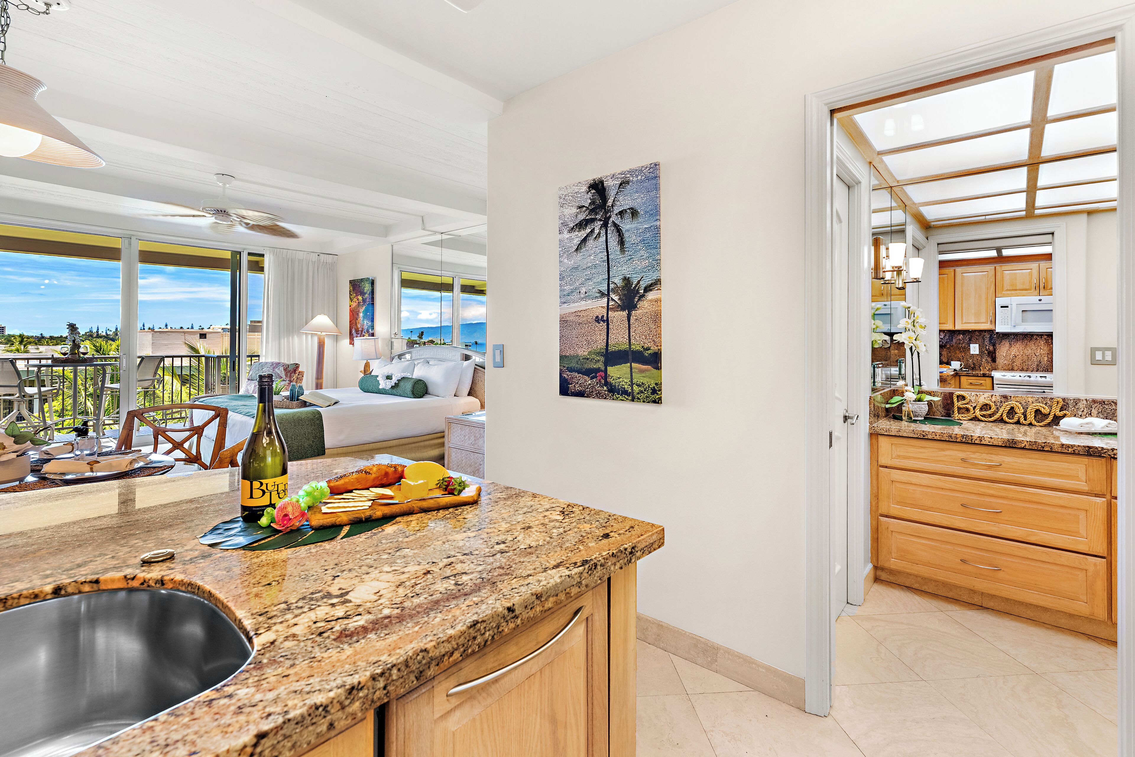 A modern kitchen with granite countertops, wooden cabinets, and a large island with a sink.