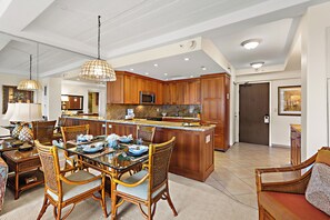 A spacious kitchen with wooden cabinets, a central island, and modern appliances. - Ocean View steps from beach, dining, shopping 970 (Lahaina)
