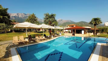 Seasonal outdoor pool, open 10:00 AM to 8:00 PM, pool umbrellas