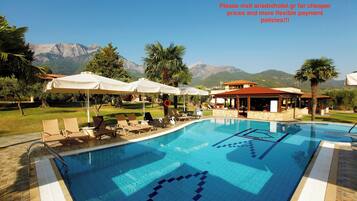 Seasonal outdoor pool, open 10:00 AM to 8:00 PM, pool umbrellas