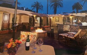 Enjoy al fresco dining and relaxation in this serene outdoor space, complete with a fire feature and comfortable seating.