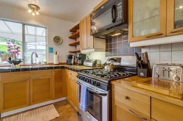 Enjoy cooking in this well-equipped kitchen with a stove, microwave, and toaster.