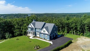 A large, two-story house with a well-maintained lawn and driveway. - Woodland View (Smithfield)