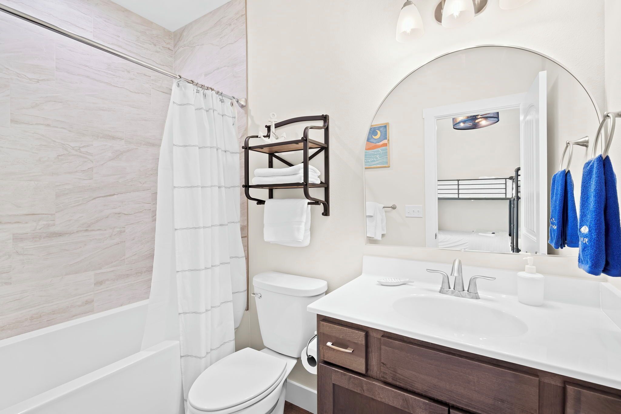 A modern bathroom with a shower, toilet, and sink.