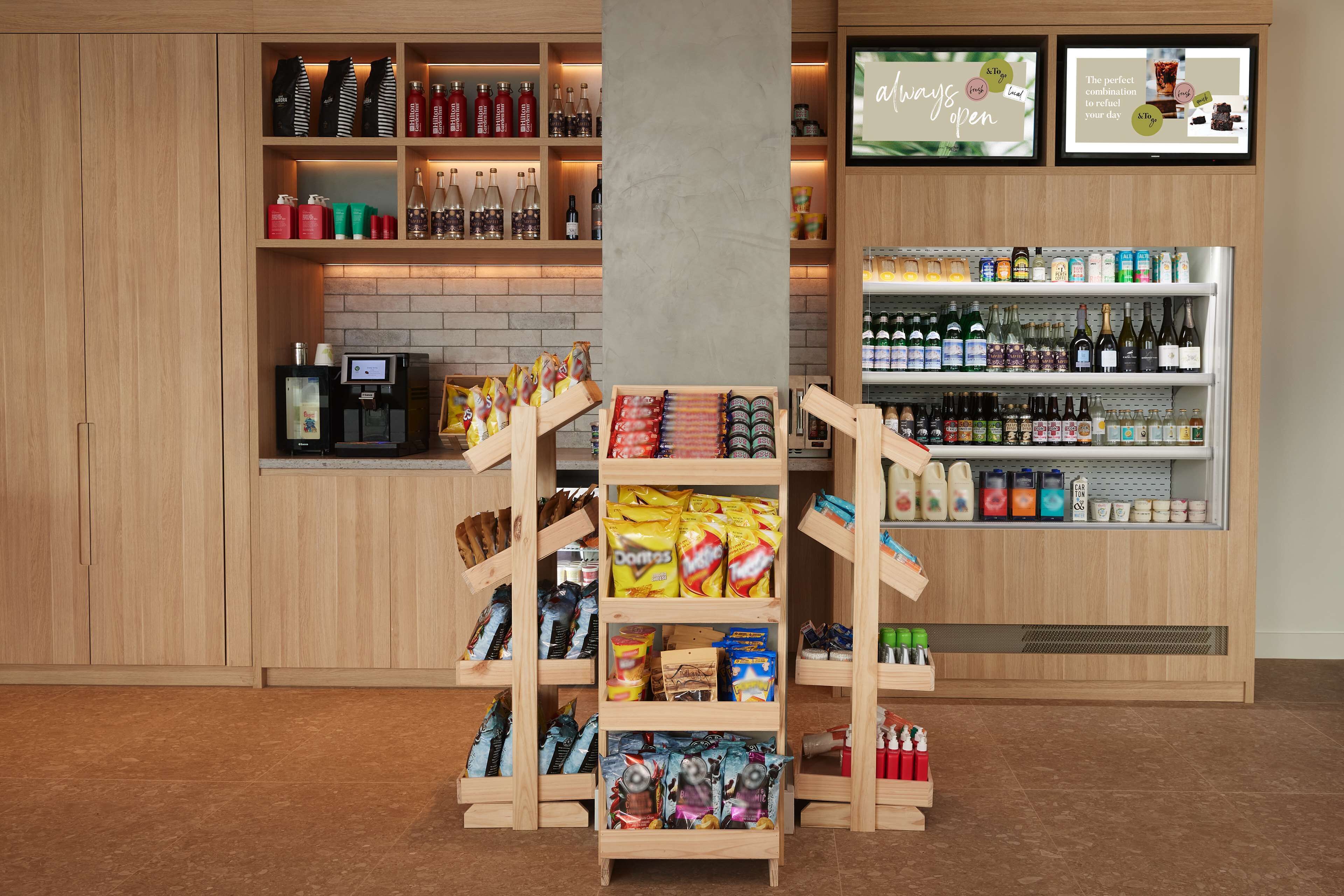 A store with shelves stocked with snacks, beverages, and bottled water.