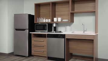 A modern kitchen with a built-in refrigerator, microwave, coffee maker, and dishwasher.