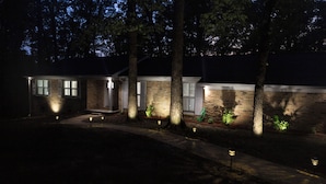 A house with a brick exterior, a front porch, and a pathway leading to the entrance. - Alabama University Events, 5 bdrm Home by Lake, sleeps 14, 5 mil to Bryant/Denny (Northport)