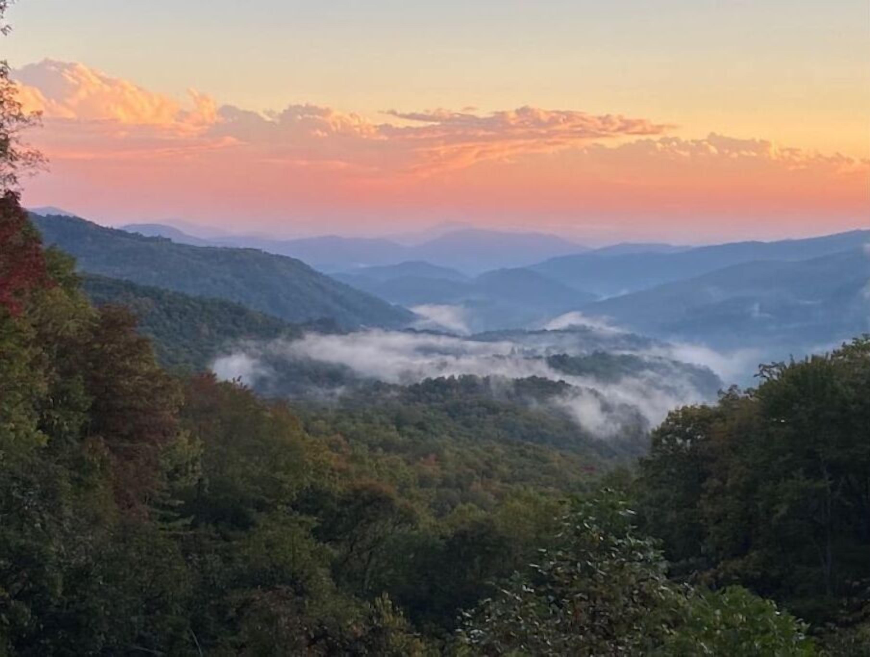 Cool off in the mountains!  Enjoy a real log home with endless views .