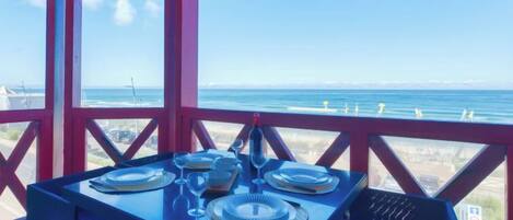 Une table dressée pour le dîner, avec vue sur l’océan.
