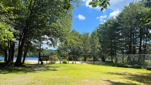 A park with a swing set, picnic tables, and a fenced area. - Cozy Lakeside Year Round Retreat ☀️🛶 🎣 🏊 🍁 🎃 🍎 🎿🏂 ❄️  & 🐾 are welcome 😊 (Hillsboro)