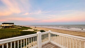 A beach house with a wooden deck and a view of the ocean. - Private Beachfront House on Bolivar Peninsula – Clean, Quiet & Steps to Sand (Bolivar Peninsula)