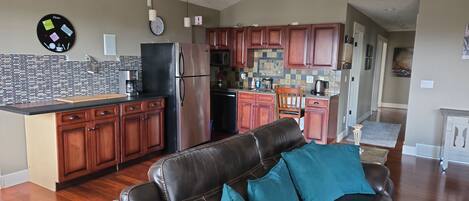 A modern kitchen with wooden cabinets, a refrigerator, and a microwave.